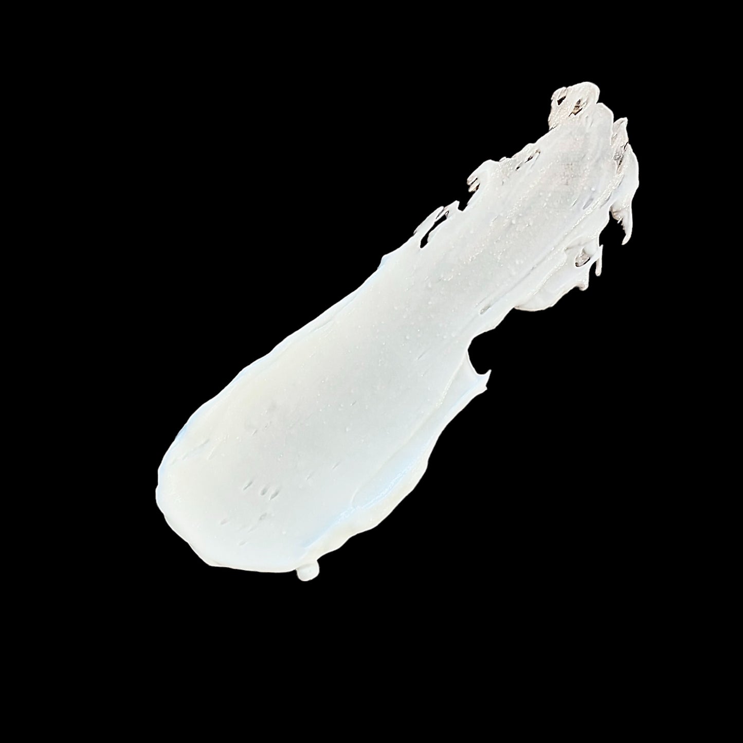 a close up of a white lotion on a black background