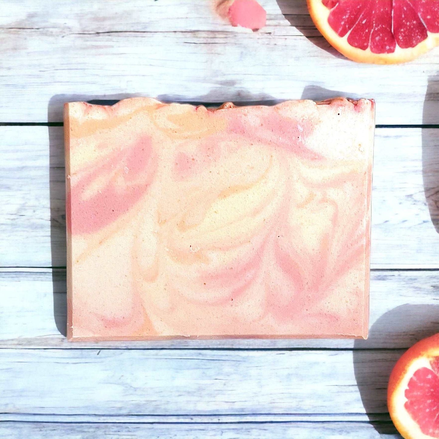 a grapefruit soap bar sitting on top of a wooden table